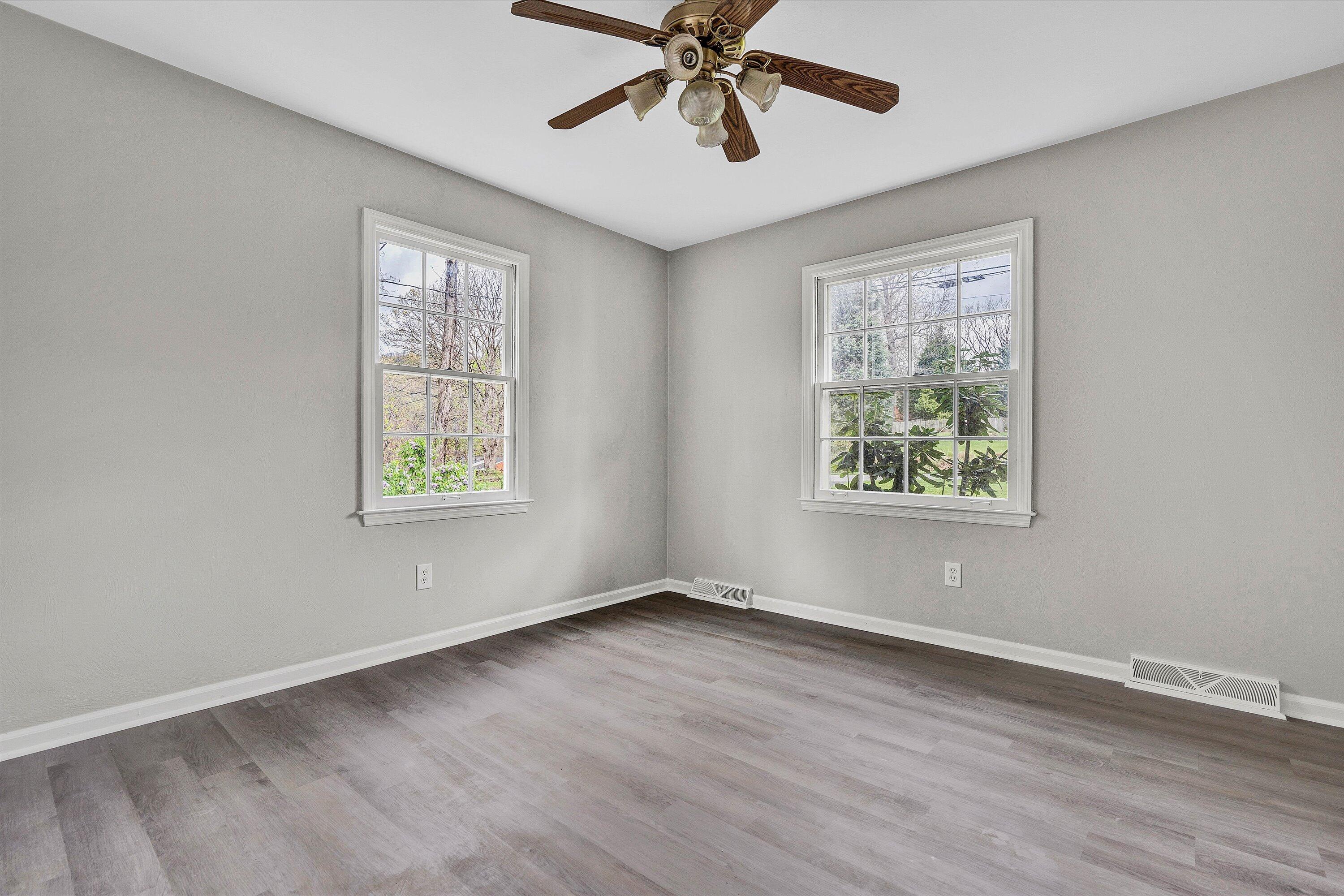 355 Pin Oak Drive Blue Ridge, VA 24064 - Photo 16 of 33 a view of an empty room with wooden floor and a window