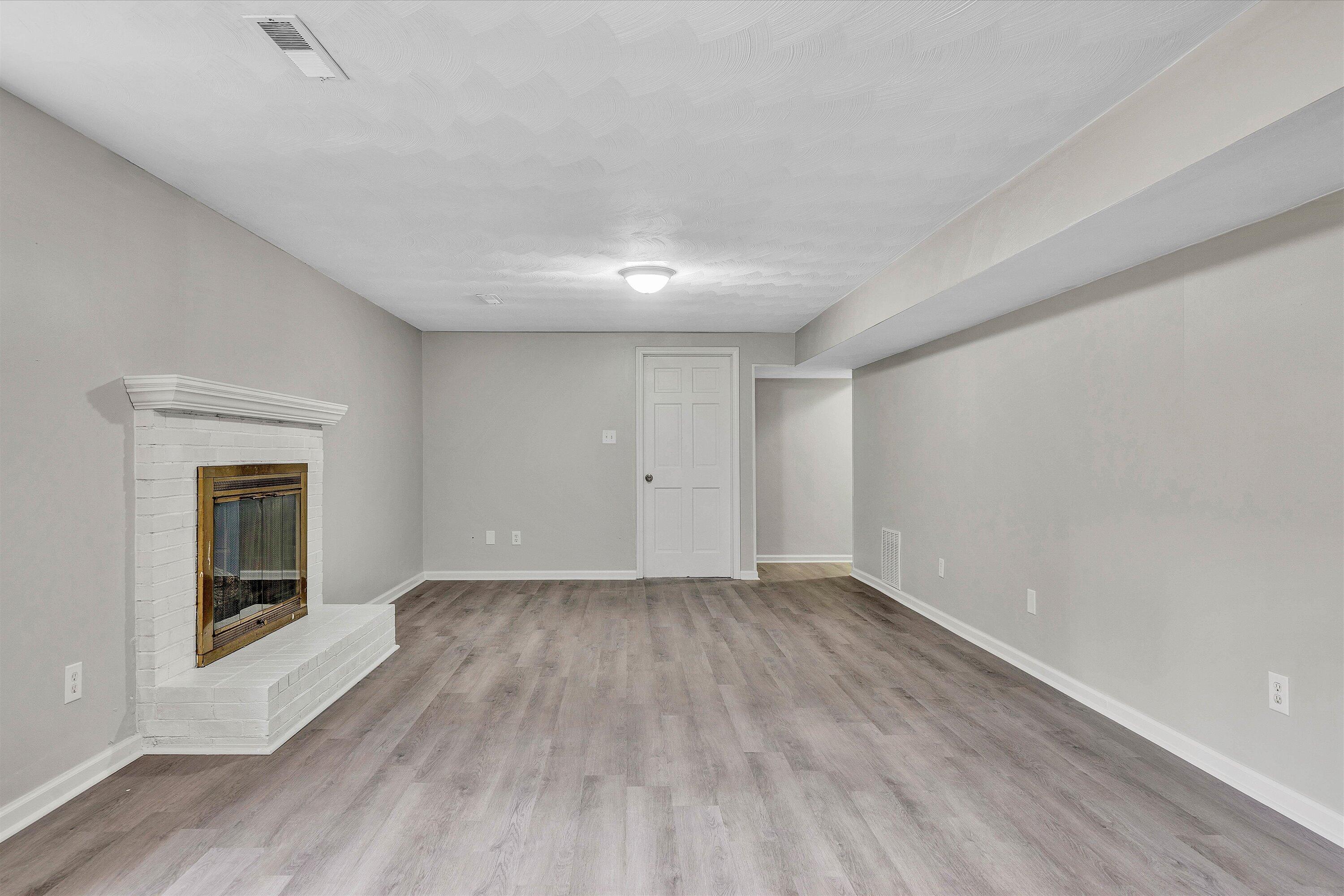 355 Pin Oak Drive Blue Ridge, VA 24064 - Photo 18 of 33 a view of an empty room with wooden floor and a window