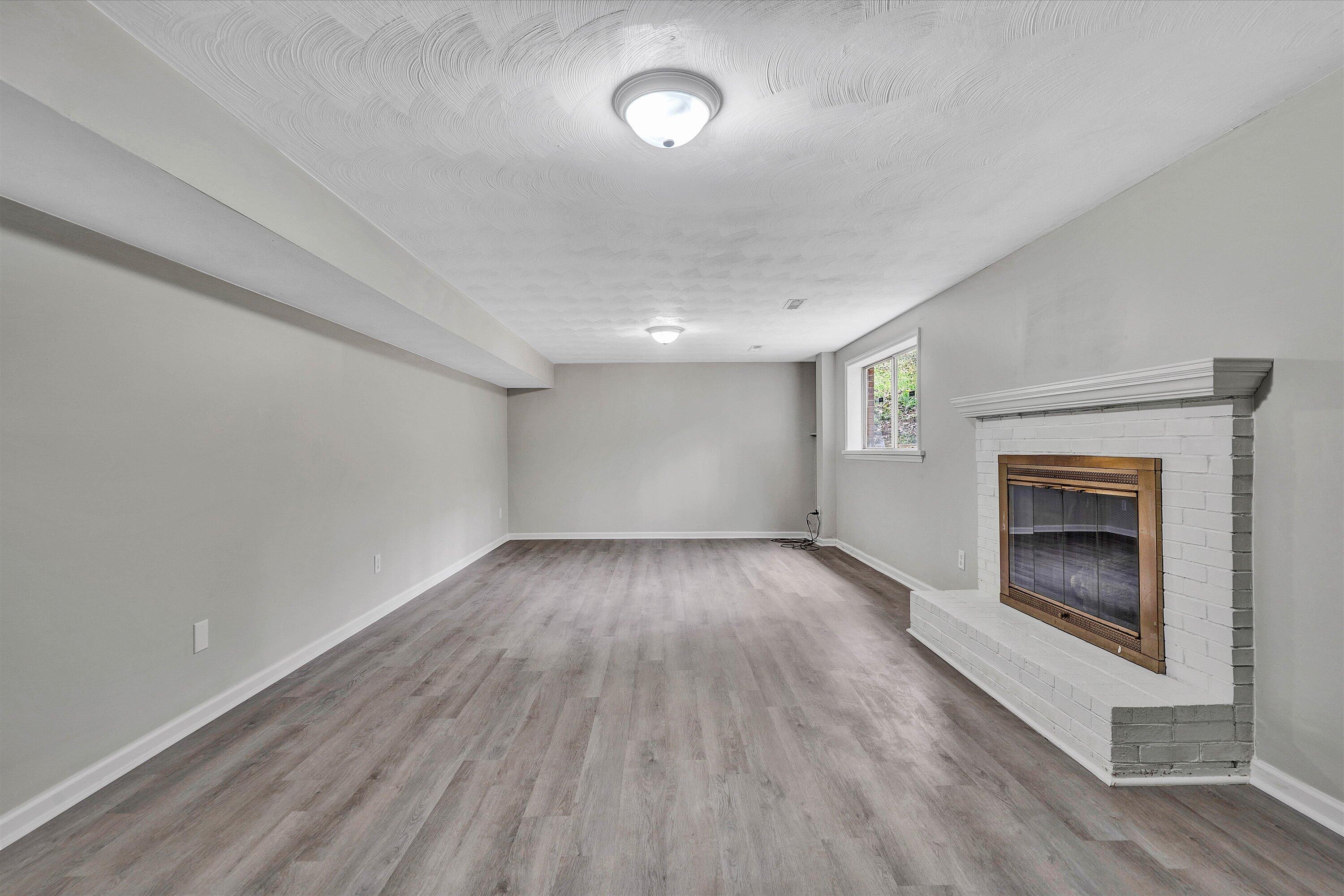 355 Pin Oak Drive Blue Ridge, VA 24064 - Photo 19 of 33 a view of an empty room with a fireplace and a window