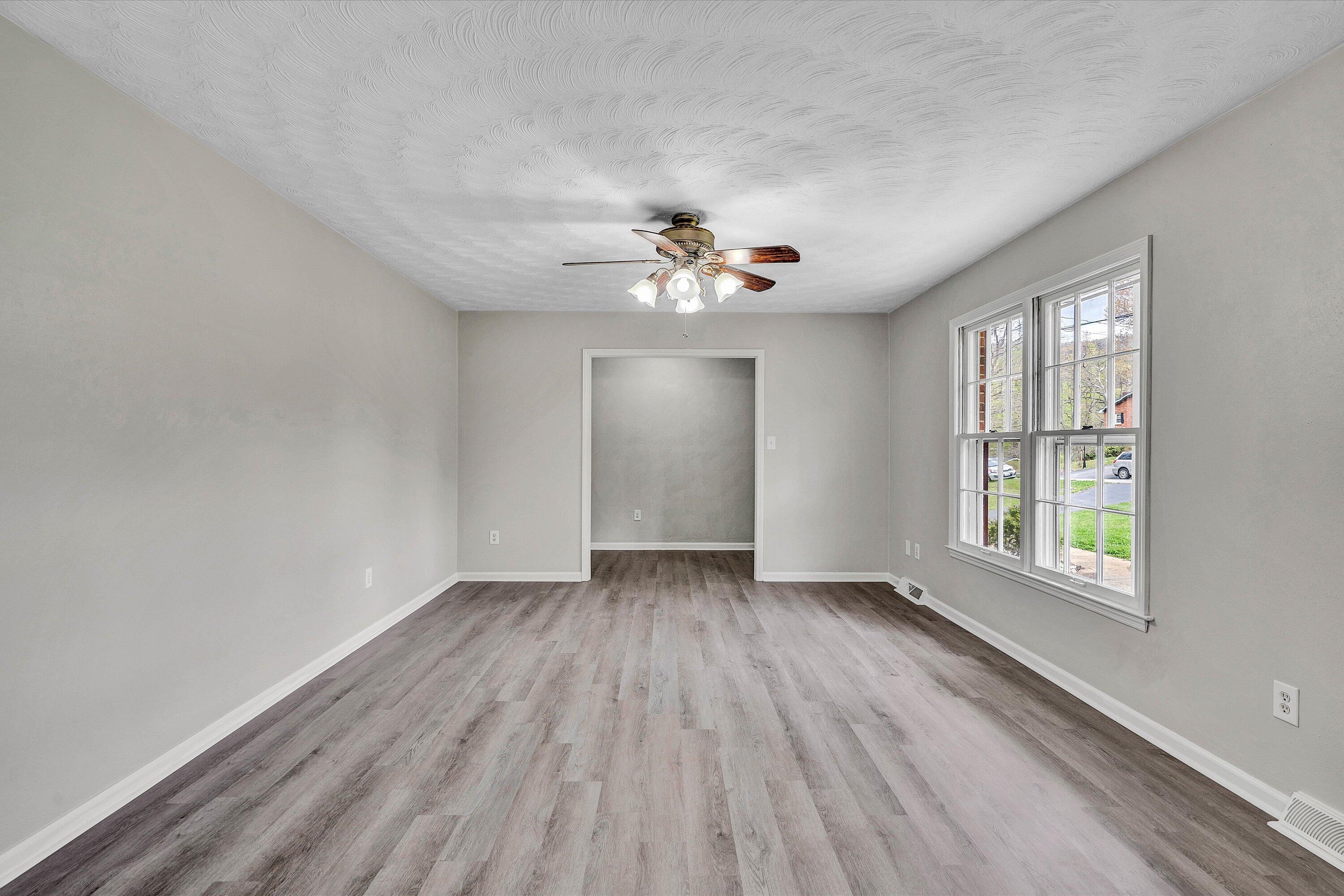 355 Pin Oak Drive Blue Ridge, VA 24064 - Photo 5 of 33 an empty room with wooden floor and windows