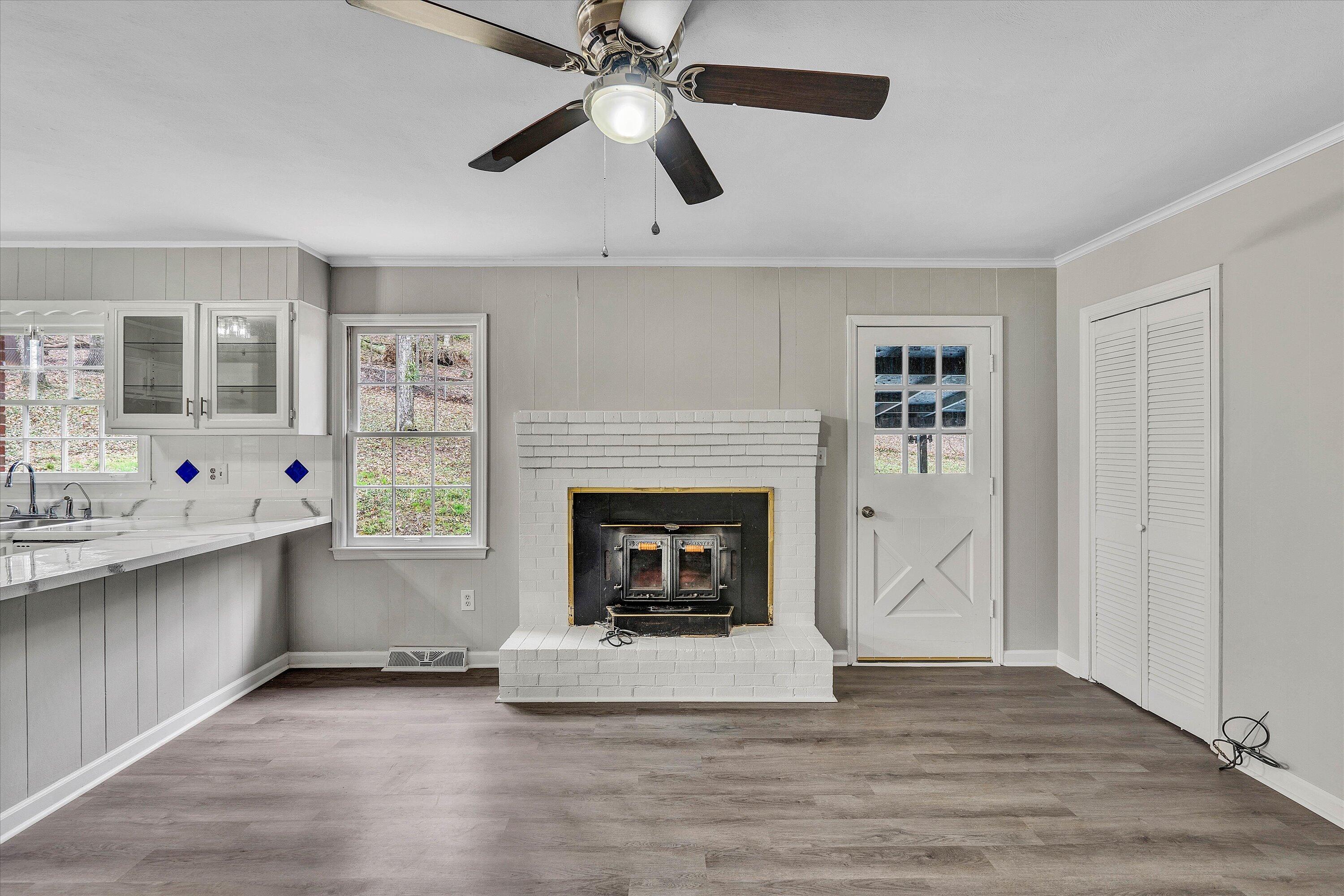 355 Pin Oak Drive Blue Ridge, VA 24064 - Photo 7 of 33 a living room with stainless steel appliances a fireplace and a ceiling fan