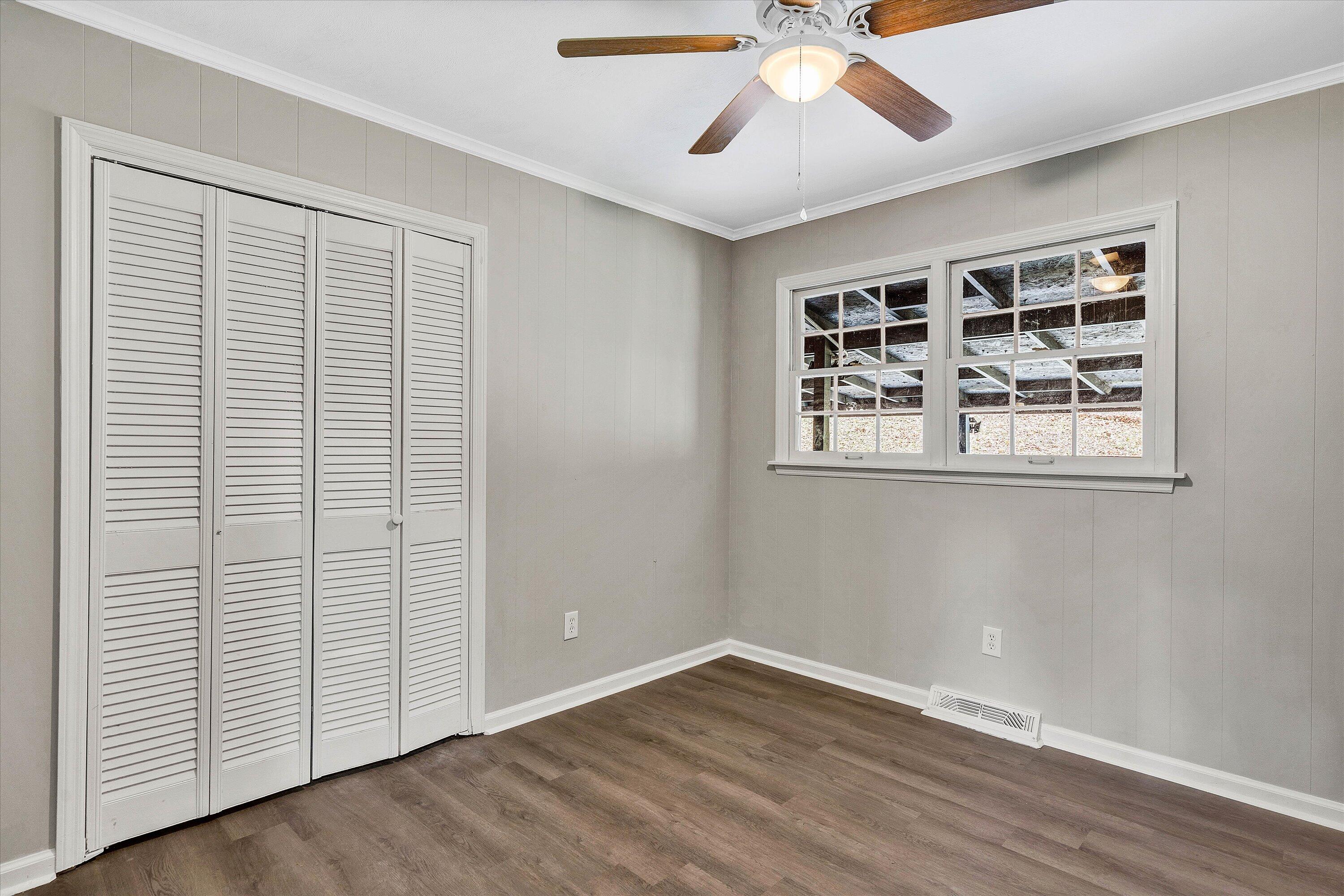 355 Pin Oak Drive Blue Ridge, VA 24064 - Photo 9 of 33 a view of an empty room with wooden floor and a ceiling fan