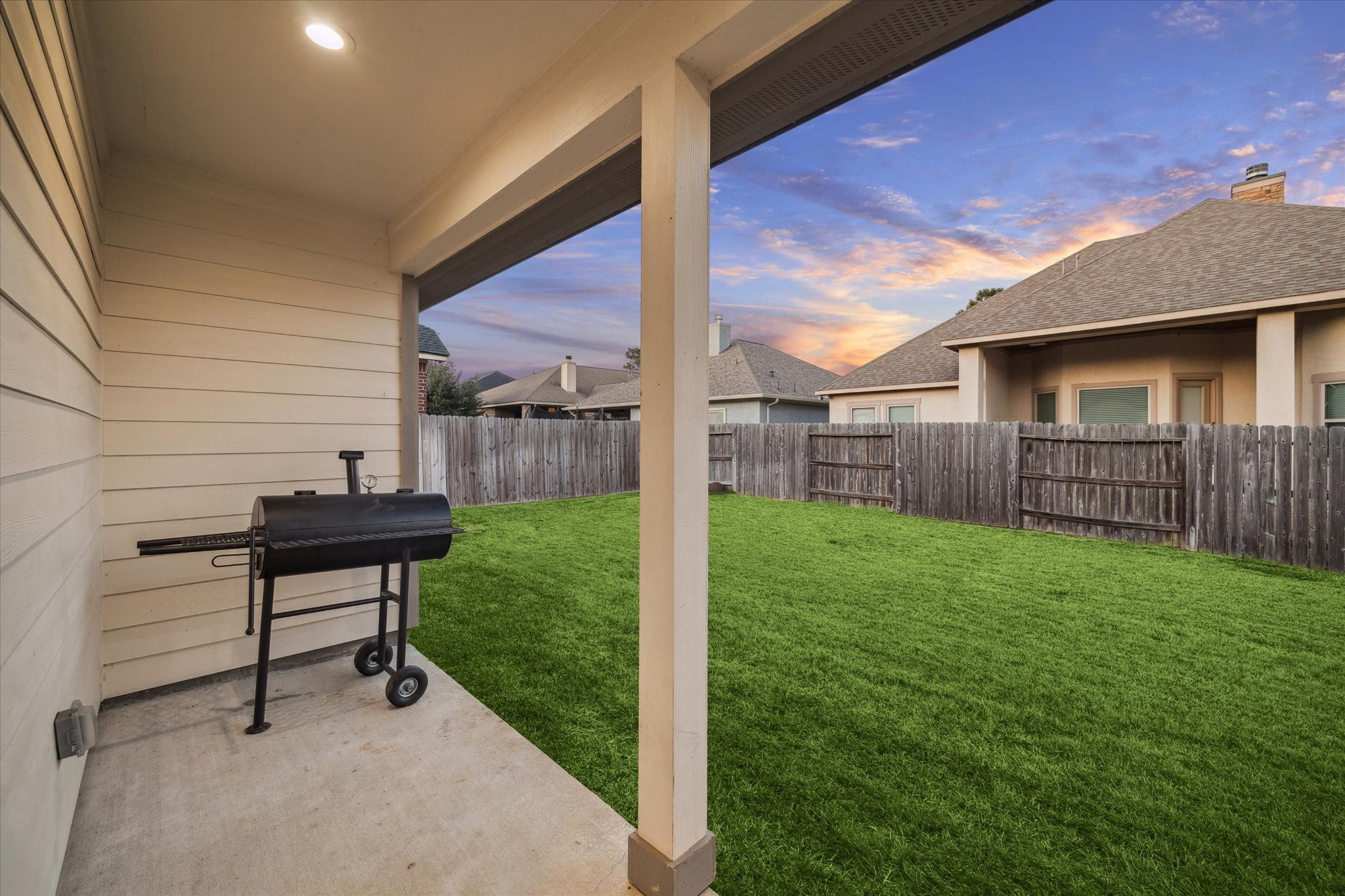 203 Hampton Glen Road Montgomery, TX 77356 - Photo 27 of 35 This cozy covered patio highlights the spacious, fenced backyard, perfect for adding a pool, a large playground for children, or a firepit. Ideal for enjoying afternoons with family and friends, this inviting outdoor space combines comfort, functionality, and charm.