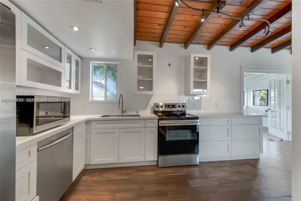 a kitchen with stainless steel appliances granite countertop a stove and a sink