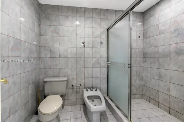 a white toilet sitting next to a bathroom sink