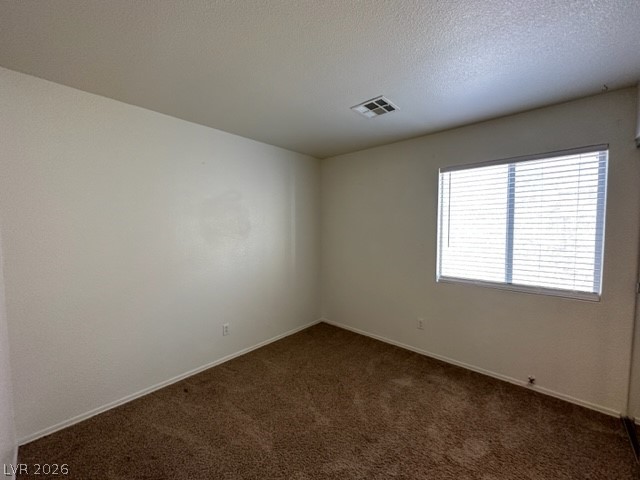 285 Spring Palms Street Henderson, NV 89012 - Photo 16 of 38 Empty room with baseboards, visible vents, and dark colored carpet