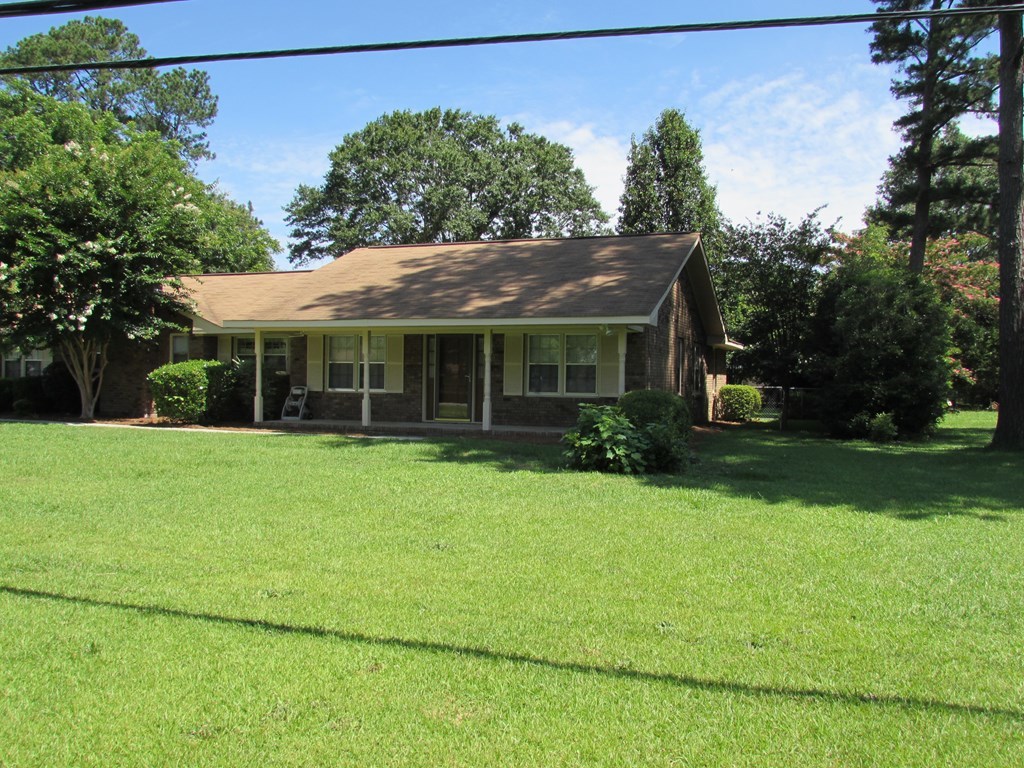 3847 Hartley Bridge Road Macon, GA 31216 - Photo 2 of 26 a front view of a house with a garden
