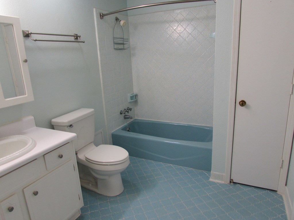 3847 Hartley Bridge Road Macon, GA 31216 - Photo 12 of 26 a white toilet sitting next to a bath tub