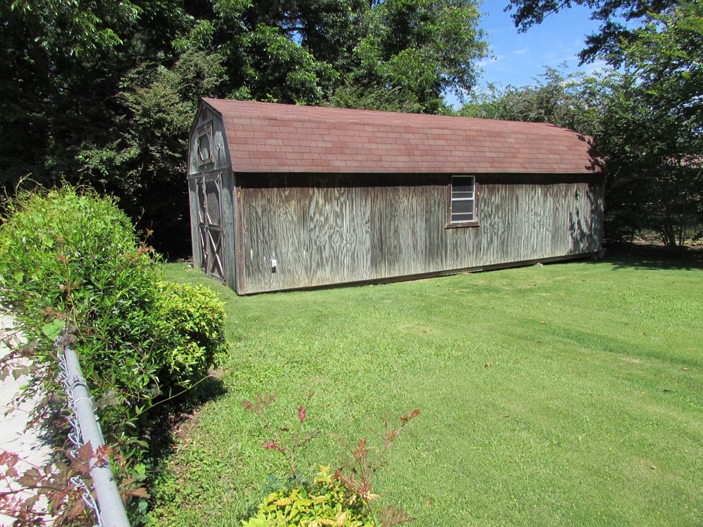 3847 Hartley Bridge Road Macon, GA 31216 - Photo 5 of 26 a view of a wooden house with a yard