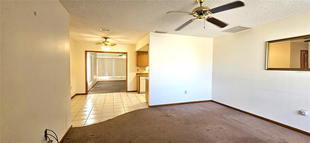 10838 Southwest 78th Court Ocala, FL 34476 - Photo 6 of 32 a view of a hallway with wooden floor and a chandelier