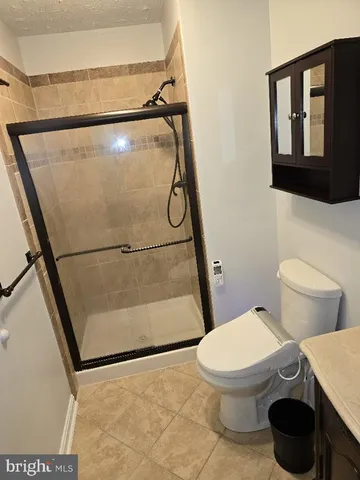 a white toilet sitting next to a shower and a sink