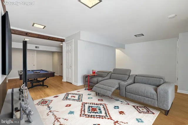 a living room with furniture and a rug