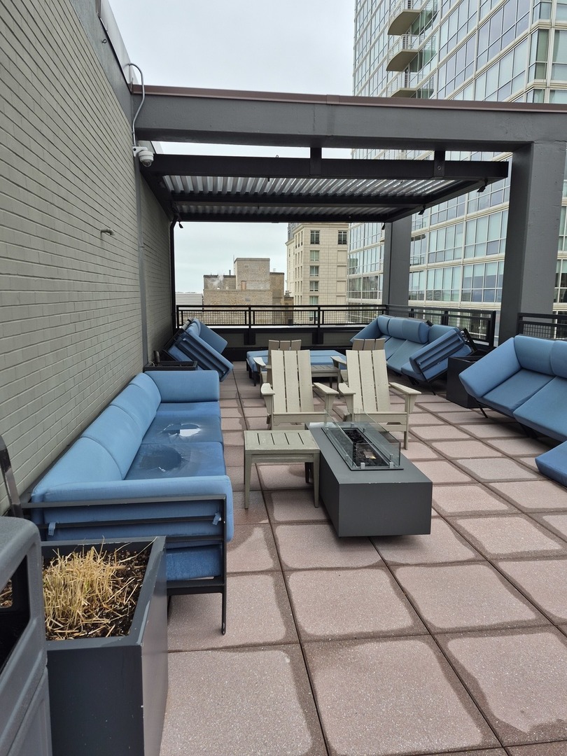 247 East Chestnut Street, Unit 1204 Chicago, IL 60611 - Photo 12 of 16 a living room with furniture and a fireplace