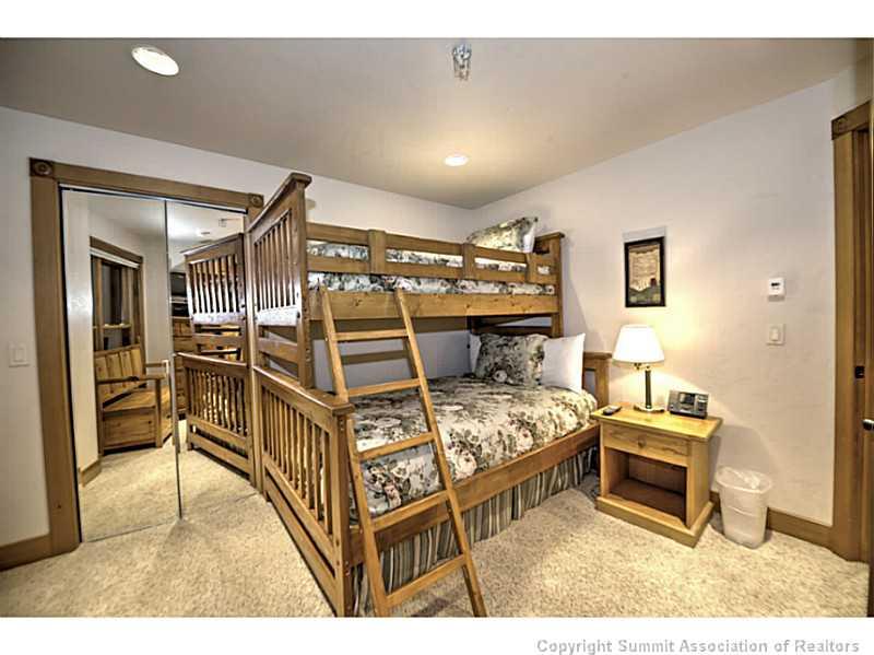 70 River Run Road, Unit 202 Keystone, CO 80435 - Photo 14 of 19 a bedroom with furniture and a flat screen tv