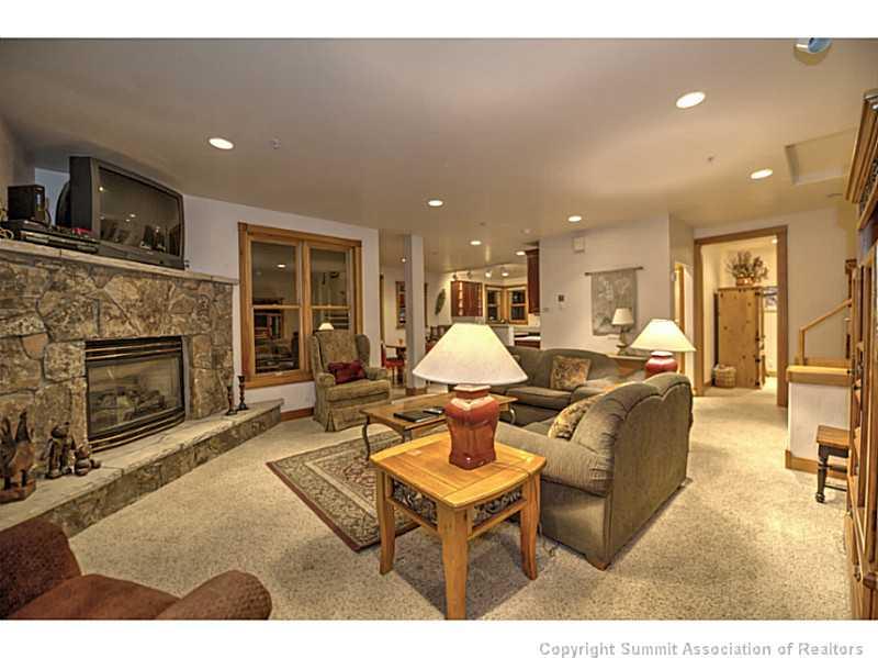 70 River Run Road, Unit 202 Keystone, CO 80435 - Photo 4 of 19 a living room with furniture a fireplace and a flat screen tv