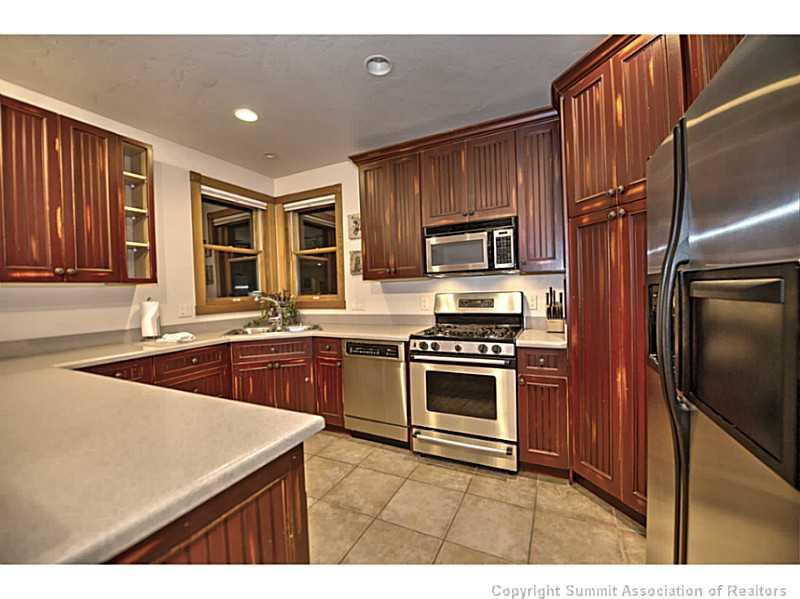 70 River Run Road, Unit 202 Keystone, CO 80435 - Photo 8 of 19 a kitchen with kitchen island granite countertop a sink stove and refrigerator