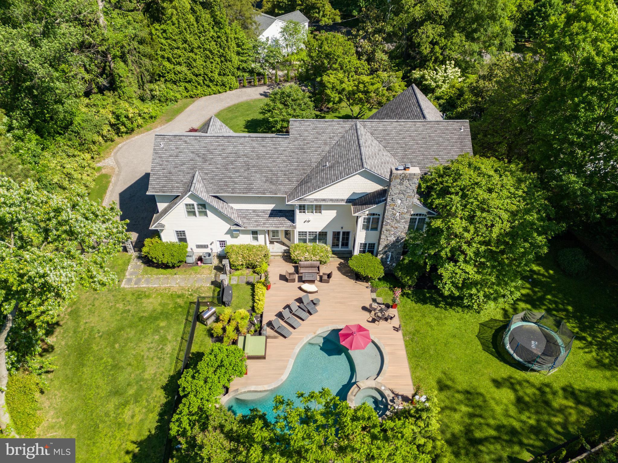 a aerial view of a house with swimming pool and garden