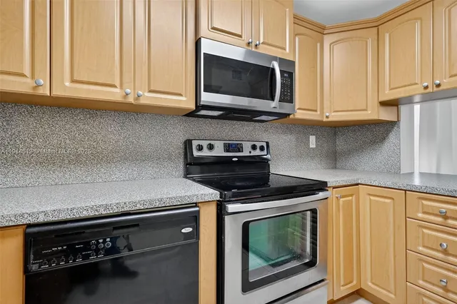 a metallic refrigerator freezer sitting in a kitchen