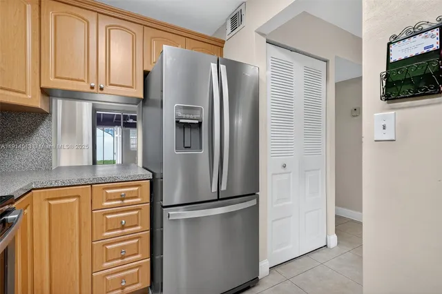 a kitchen with stainless steel appliances granite countertop a sink and a microwave