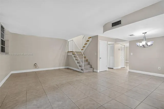 an empty room with a ceiling fan and a window