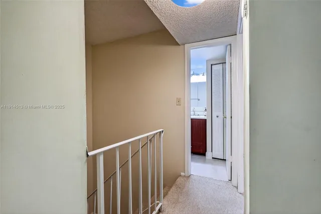 a bathroom with a sink vanity mirror and toilet