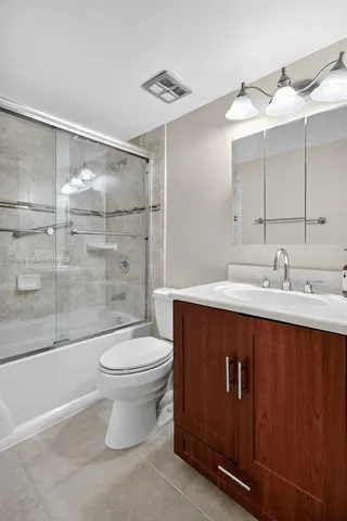 an empty room with a chandelier fan