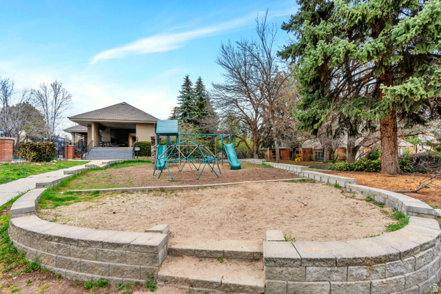 3221 North Shadowbrook Circle Provo, UT 84604 - Photo 24 of 29 Outdoor play area featuring a sand base and a multi-component play structure with a slide and climbing frame