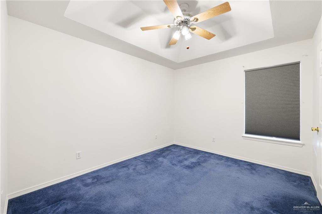 4822 East Canton Road Edinburg, TX 78542 - Photo 13 of 28 an empty room with a window and a ceiling fan