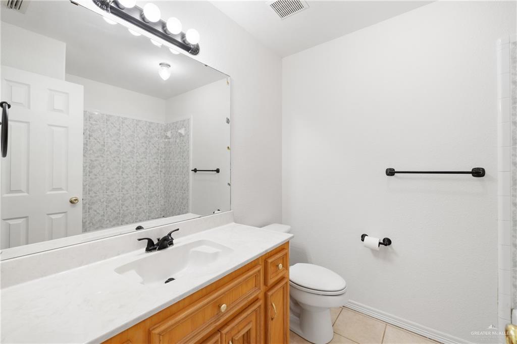 4822 East Canton Road Edinburg, TX 78542 - Photo 14 of 28 a bathroom with a sink toilet and shower