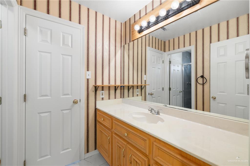 4822 East Canton Road Edinburg, TX 78542 - Photo 17 of 28 a bathroom with a sink and a mirror