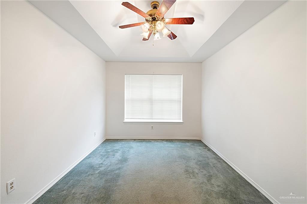 4822 East Canton Road Edinburg, TX 78542 - Photo 6 of 28 an empty room with a window and a fan