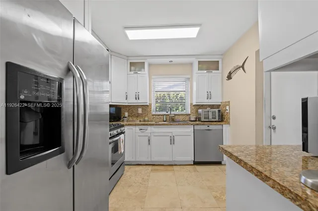 a kitchen with a sink stove and refrigerator