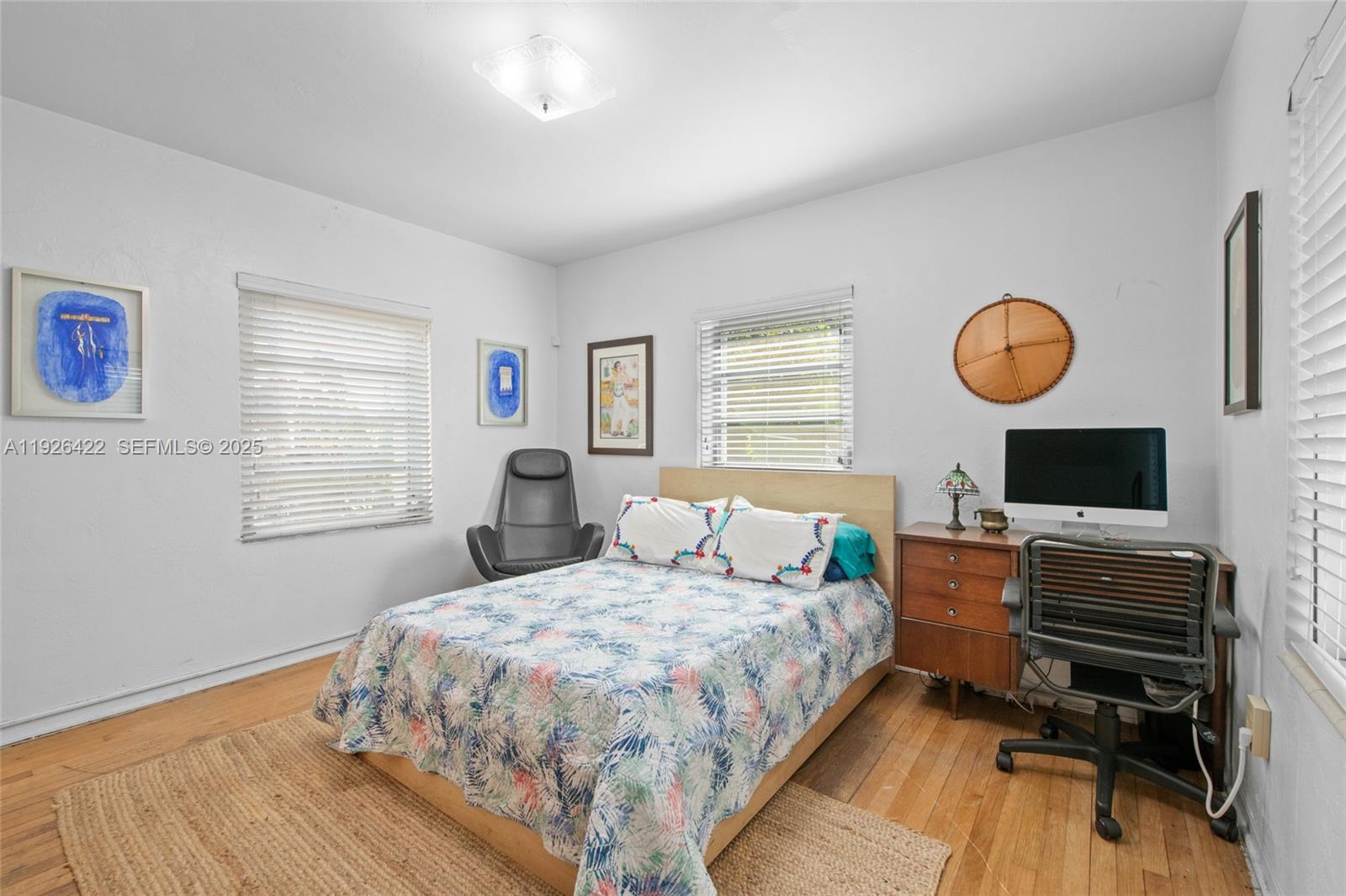 2460 Southwest 24th Street Miami, FL 33145 - Photo 16 of 36 a bedroom with a bed and wooden floor