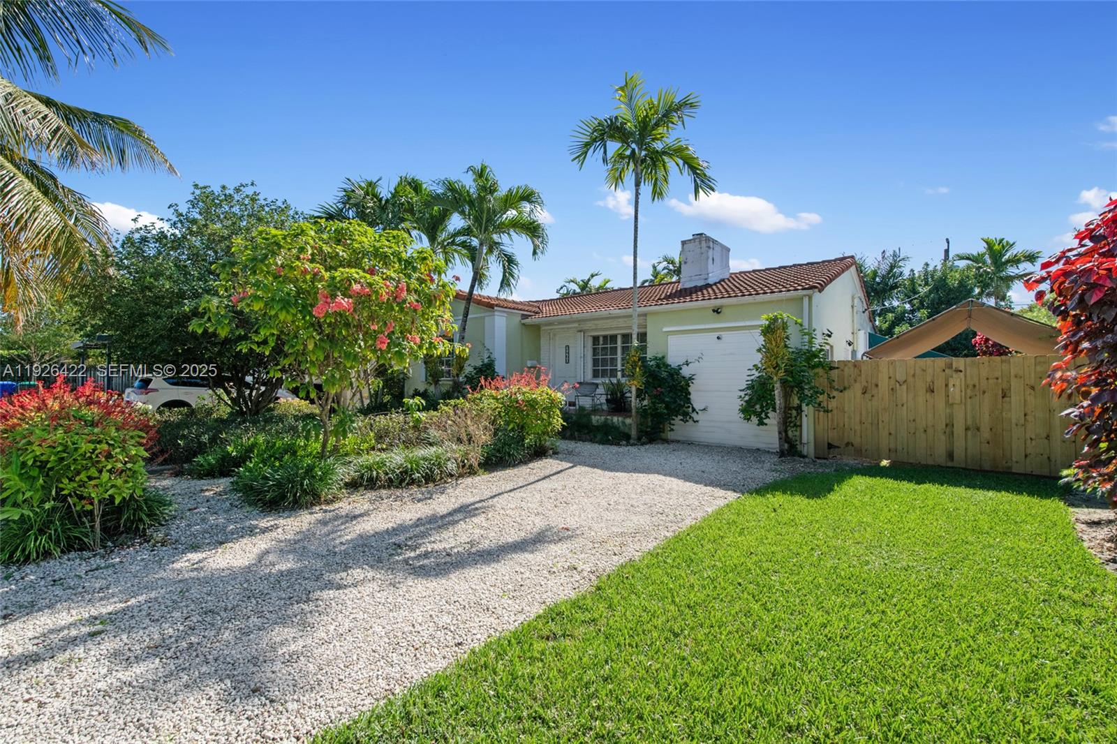 2460 Southwest 24th Street Miami, FL 33145 - Photo 2 of 36 a front view of a house with a yard and potted plants