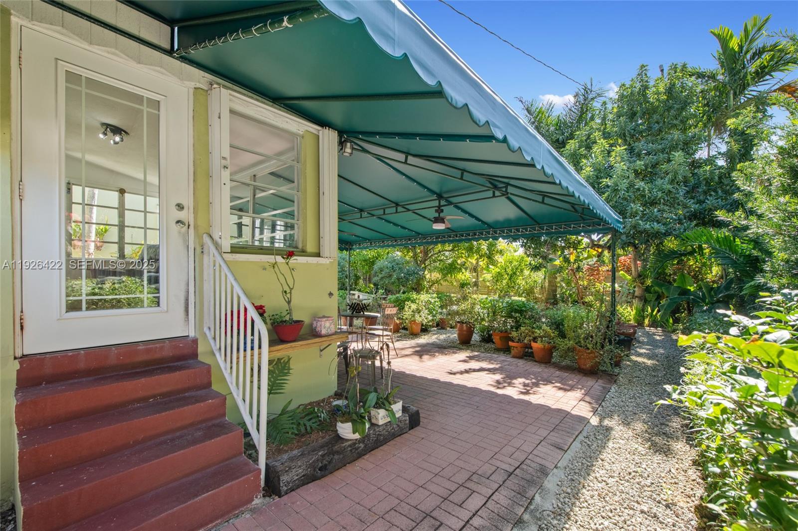 2460 Southwest 24th Street Miami, FL 33145 - Photo 26 of 36 a view of a patio with table and chairs under an umbrella