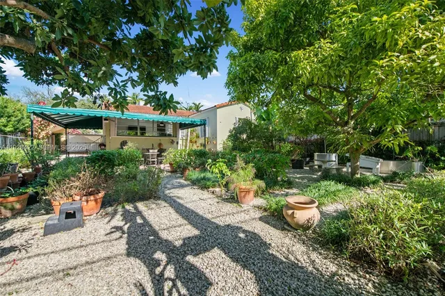 a view of a chair and tables in the backyard