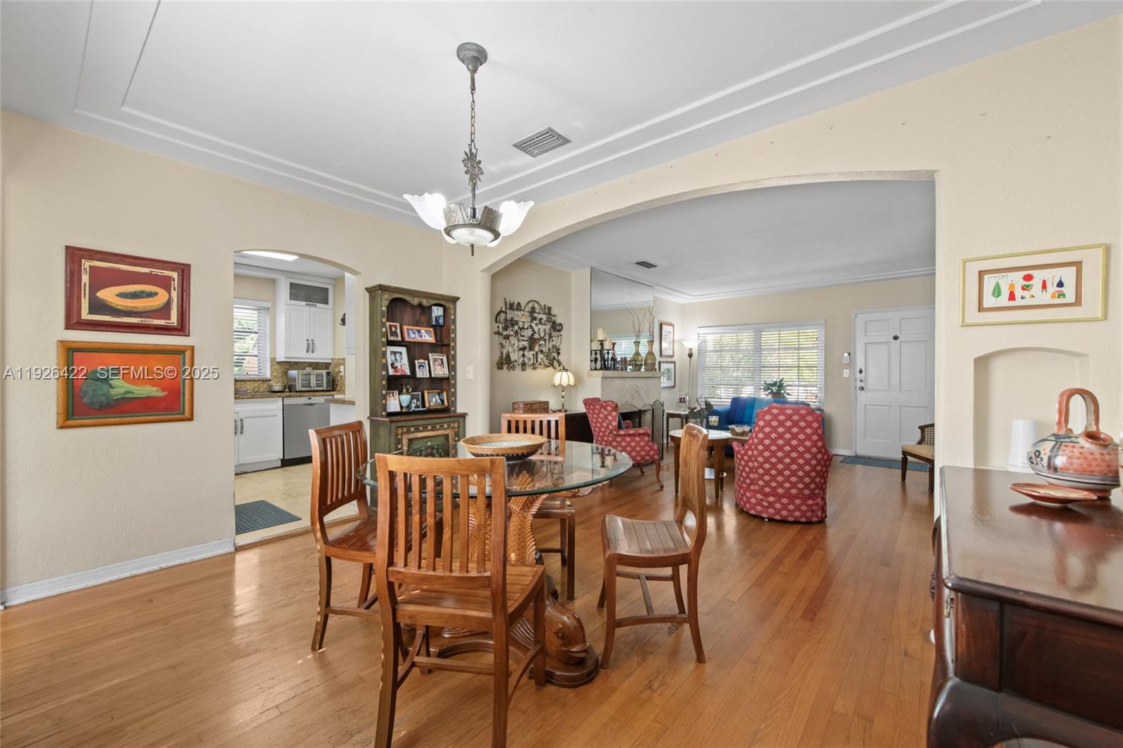 2460 Southwest 24th Street Miami, FL 33145 - Photo 9 of 36 a view of a dining room with furniture wooden floor and chandelier