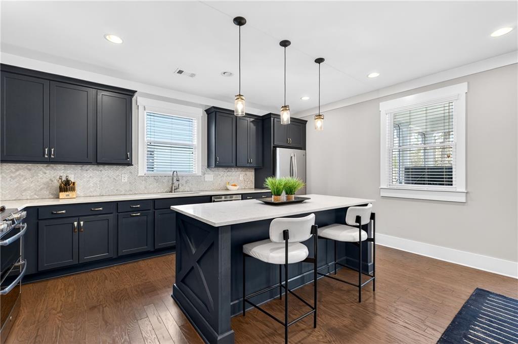 4072 Comanche Drive Tucker, GA 30084 - Photo 15 of 43 a kitchen with stainless steel appliances granite countertop wooden cabinets a stove a sink a window and chairs