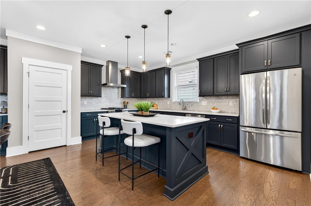 4072 Comanche Drive Tucker, GA 30084 - Photo 16 of 43 a kitchen with stainless steel appliances a stove a sink a refrigerator a center island and a cabinets