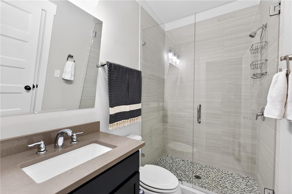 4072 Comanche Drive Tucker, GA 30084 - Photo 20 of 43 a bathroom with a sink a toilet a mirror and shower
