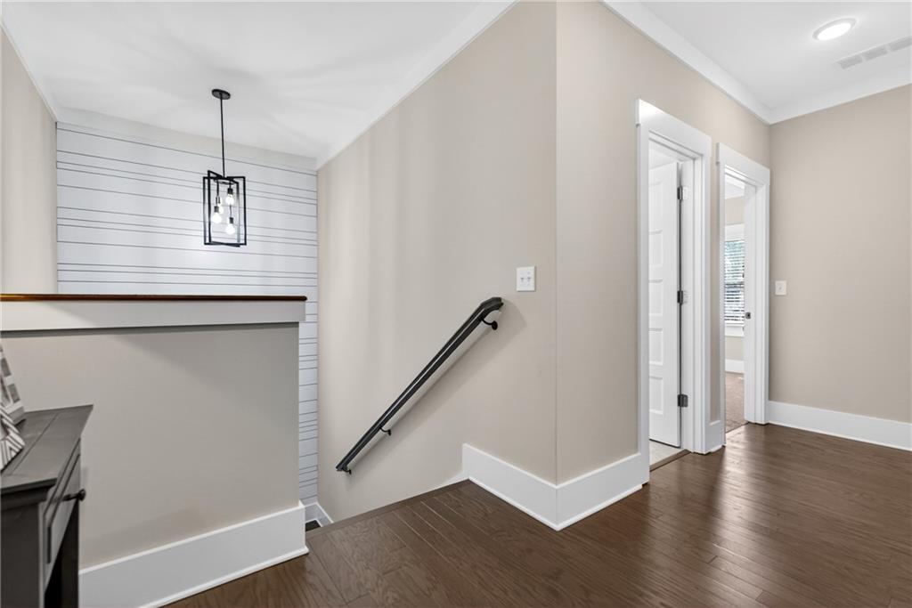 4072 Comanche Drive Tucker, GA 30084 - Photo 22 of 43 a view of a hallway with wooden floor and stairs
