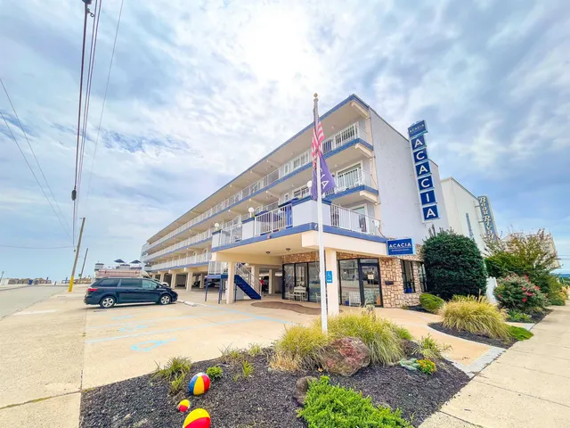 a front view of multiple houses with yard