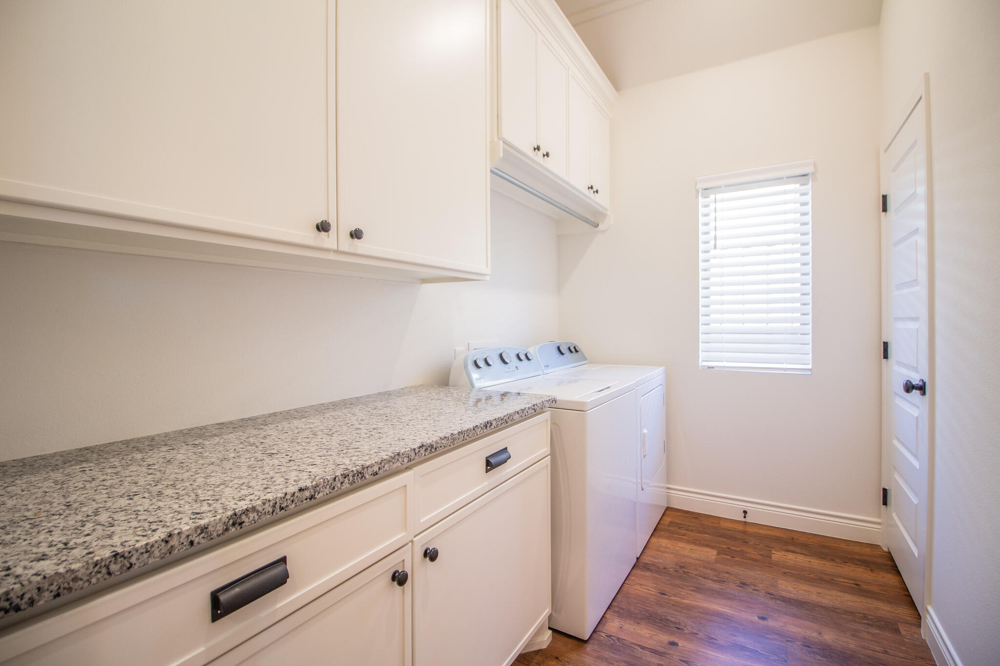 4019 137th Street Lubbock, TX 79423 - Photo 23 of 46 a utility room with cabinets washer and dryer