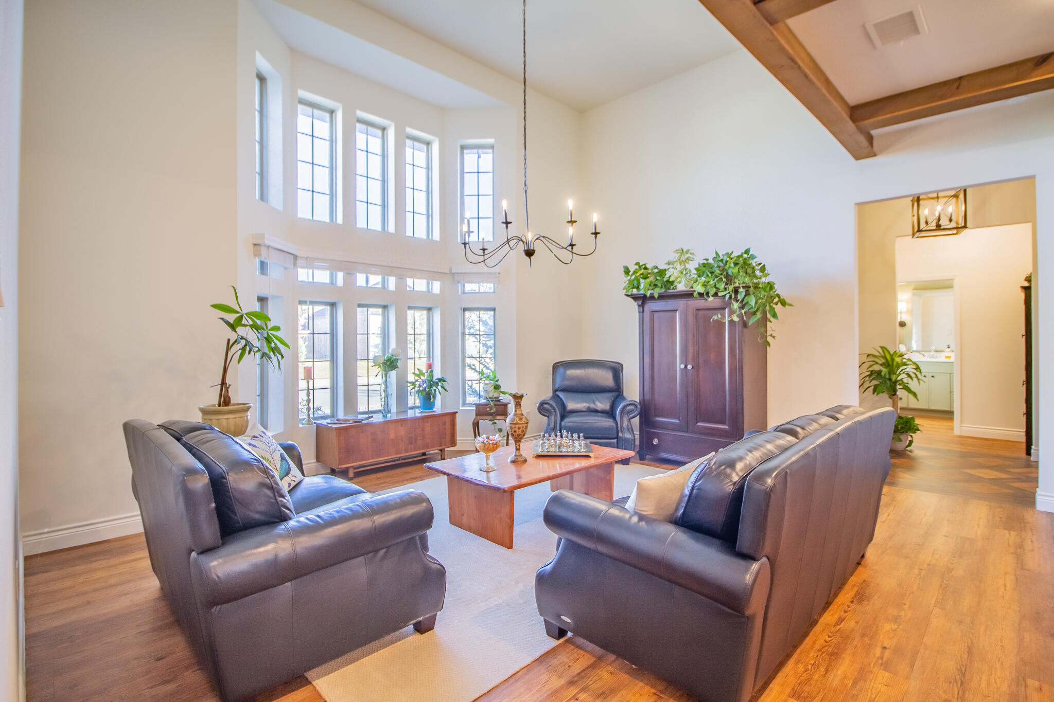 4019 137th Street Lubbock, TX 79423 - Photo 6 of 46 a living room with furniture and a chandelier