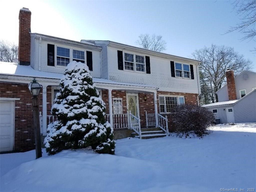 a view of a house with a yard and garden