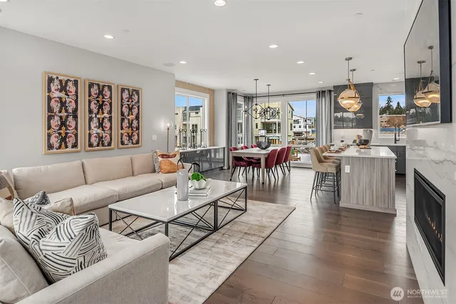 a living room with fireplace furniture and a large window