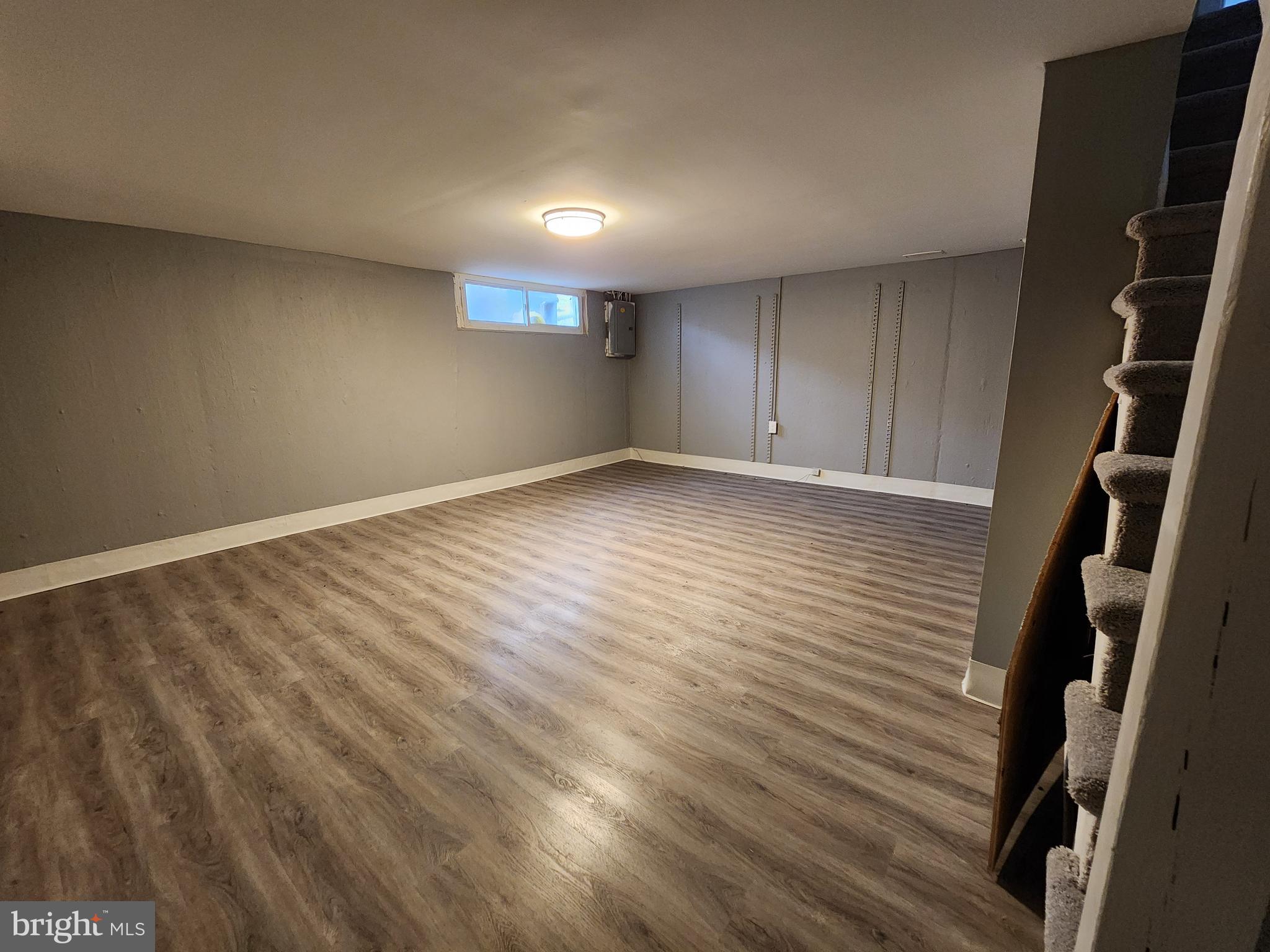 1333 Adair Road Brookhaven, PA 19015 - Photo 14 of 16 a view of an empty room with wooden floor and cabinets