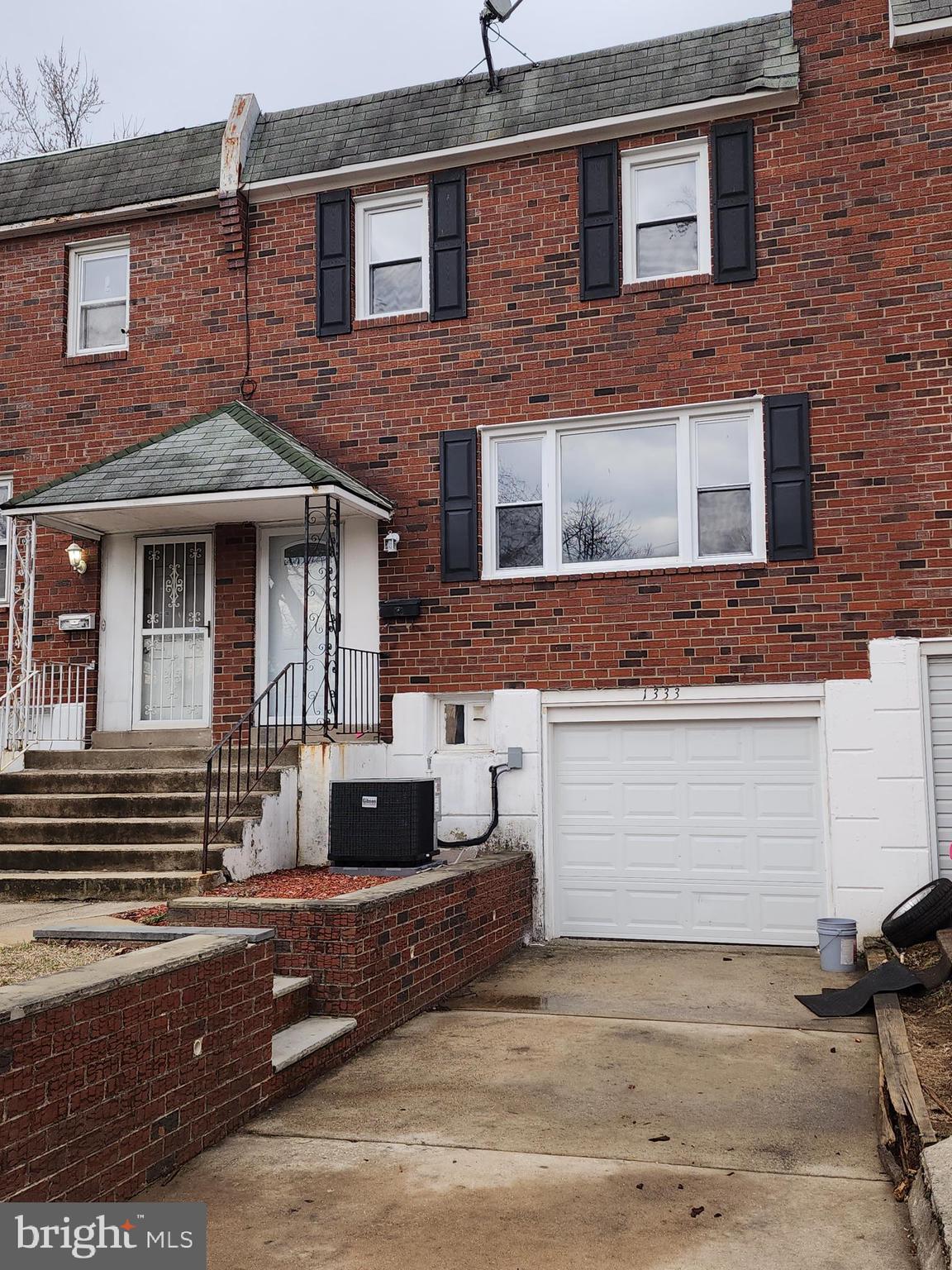 1333 Adair Road Brookhaven, PA 19015 - Photo 15 of 16 a front view of a house with a garage