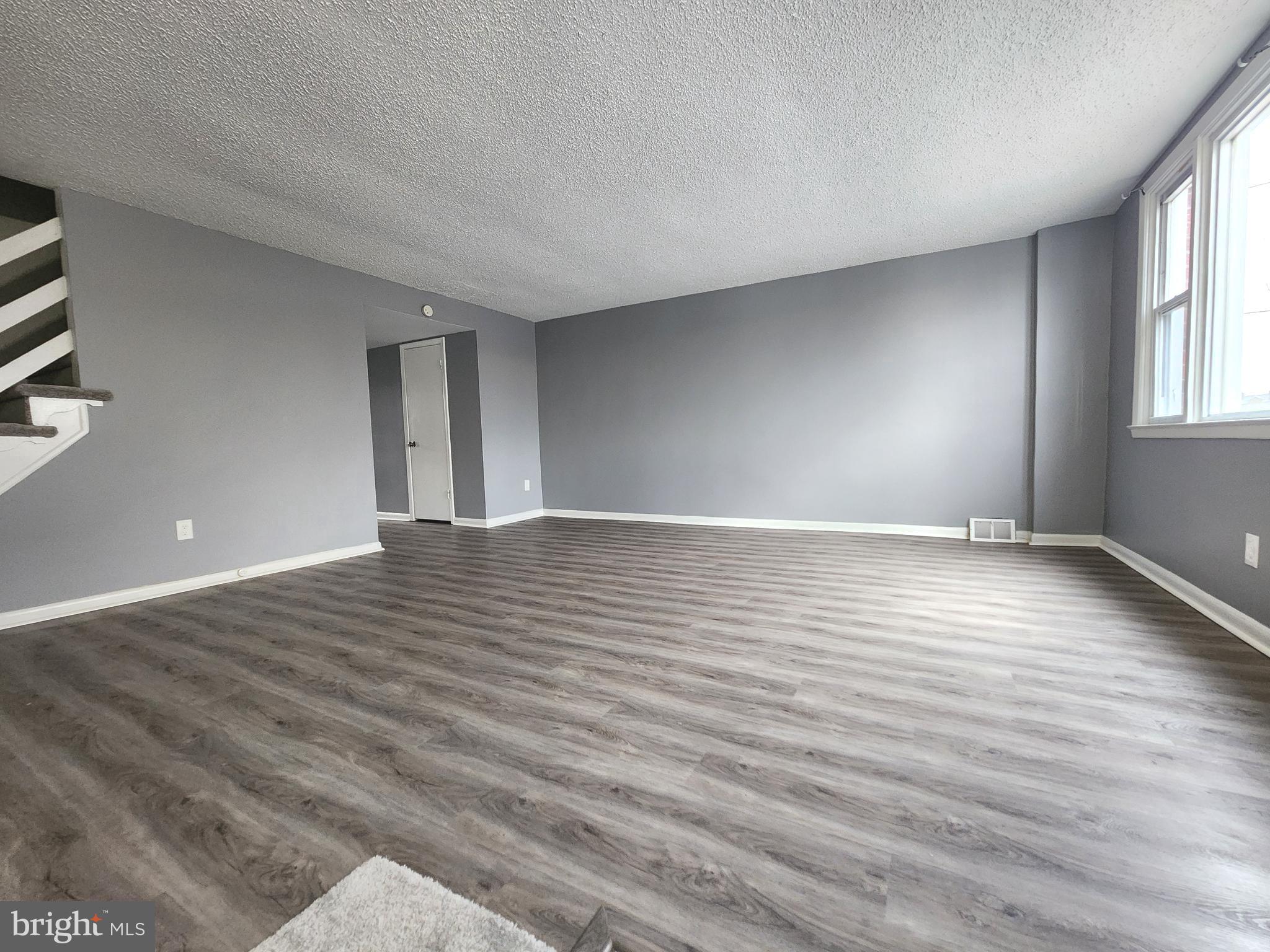 1333 Adair Road Brookhaven, PA 19015 - Photo 3 of 16 wooden floor in an empty room with a window