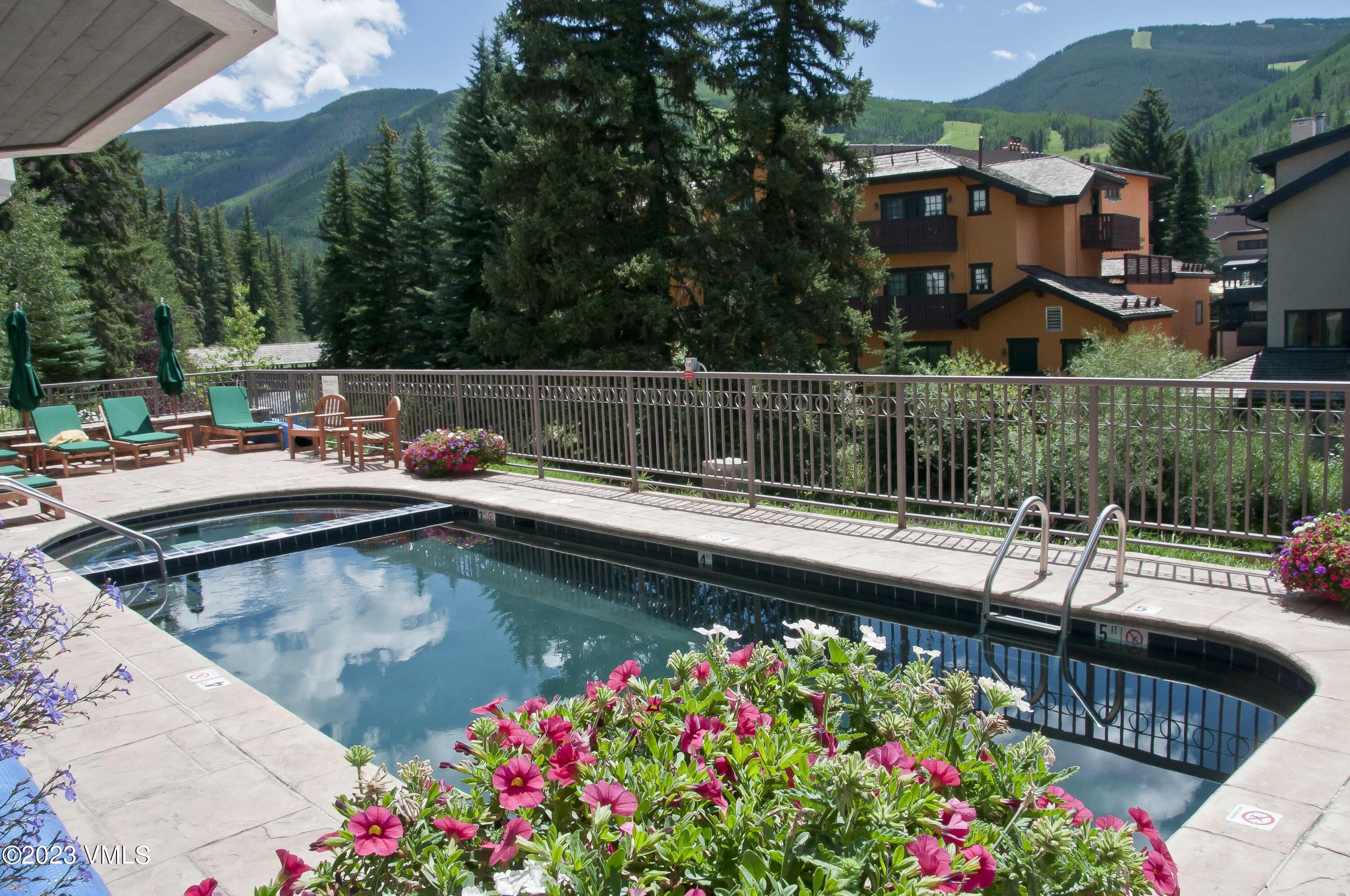 242 East Meadow Drive, Unit 1041 Vail, CO 81657 - Photo 17 of 46 a view of swimming pool with outdoor seating and flowers
